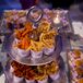 Jenna and Tom had plenty of extra snacks for their guests. We can't get over this display of french fries and mini sliders. Who knew mini fry cups on a metallic tiered display could turn this snack into chic?