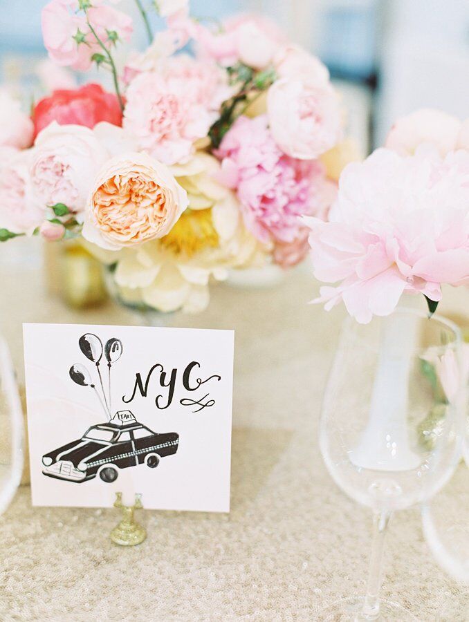 The custom-painted table names were small drawings of locations that were important in the couple's lives.