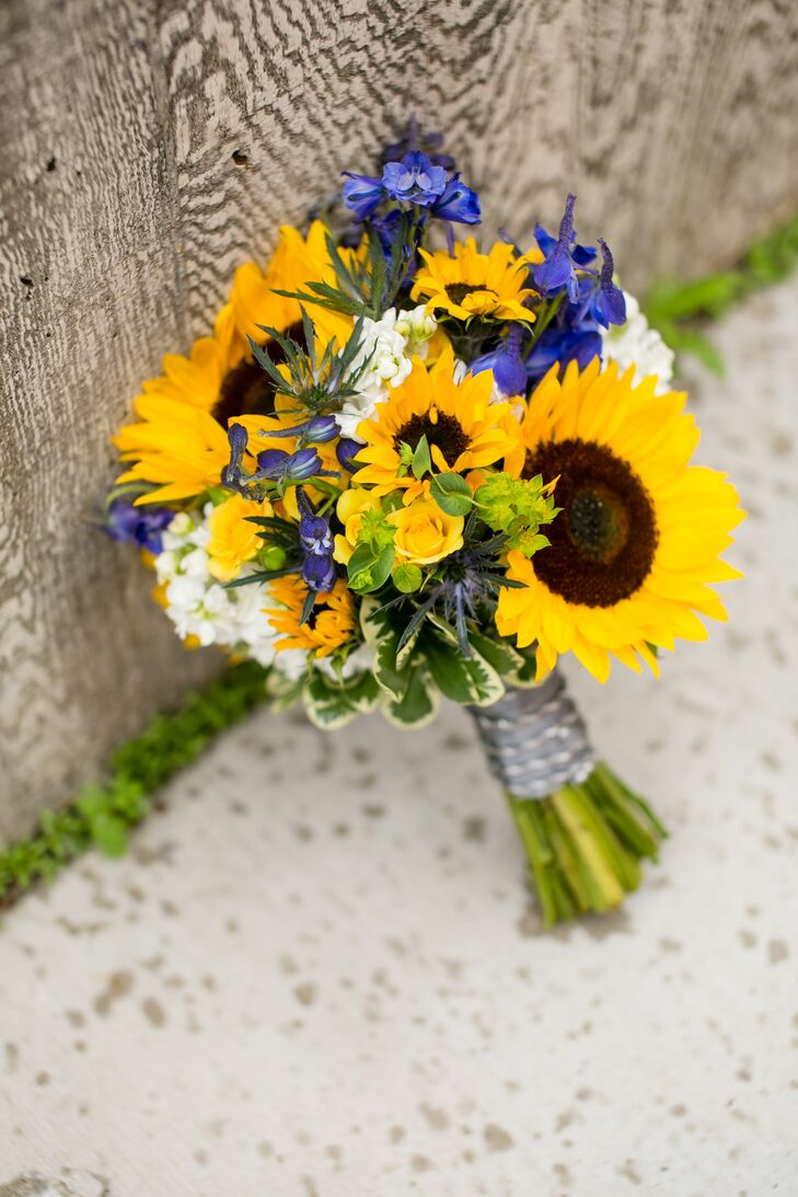 Dawn carried a bouquet with bright sunflowers, blue irises and white stock flowers.