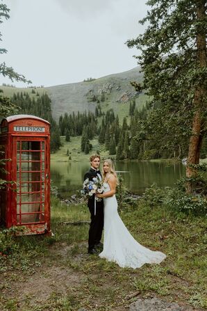 Groom in Tuxedo and Bride in Fitted Lace Gown With Wildflower Bouquet and British Phone Booth