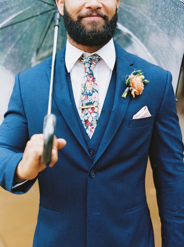 Groom in Navy Suit and Floral Tie With Umbrella