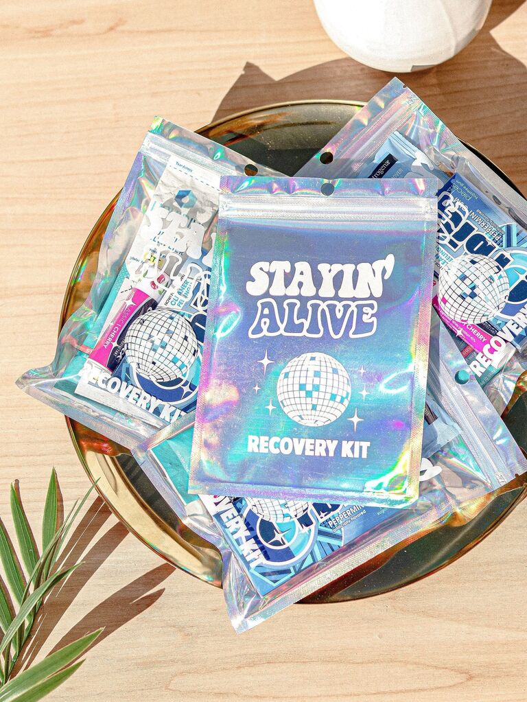 Hangover kits in glittery plastic bags that read Stayin' Alive bachelorette party favor