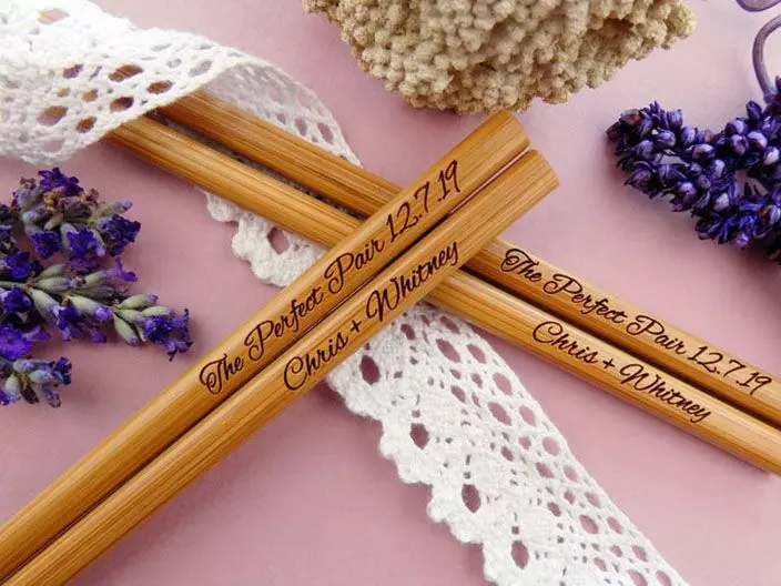 Wooden chopsticks personalized with the couples' names. 