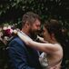 Romantic Couple with Braided Bridal Updo and Modern Bouquet