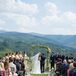 The couple lined their ceremony aisle with white rose petals, small gold lanterns and candles for a romantic flair.
