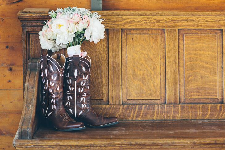 In place of traditional heels, Madison played up the wedding's ranch theme by choosing a pair of dark brown Ariat cowboy boots detailed with a dainty floral print.