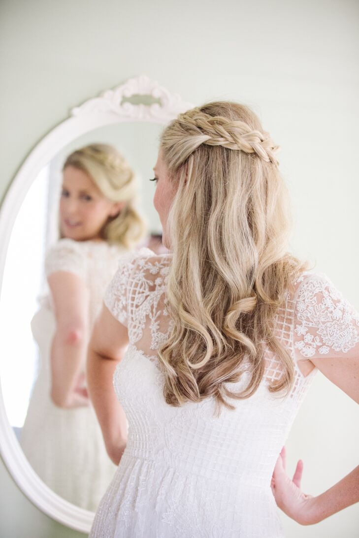 Hair and makeup artist Pam Geiger used a curling iron to give Jill loose natural waves. She then took two sections of hair from the front and worked them into a braid, which wrapped around the crown of Jill’s head, adding in a few small flowers as a decorative touch. “I always knew I wanted to wear my hair the way I did on my wedding day, so it didn’t hurt that the feel of the dress was a perfect match!” says Jill.