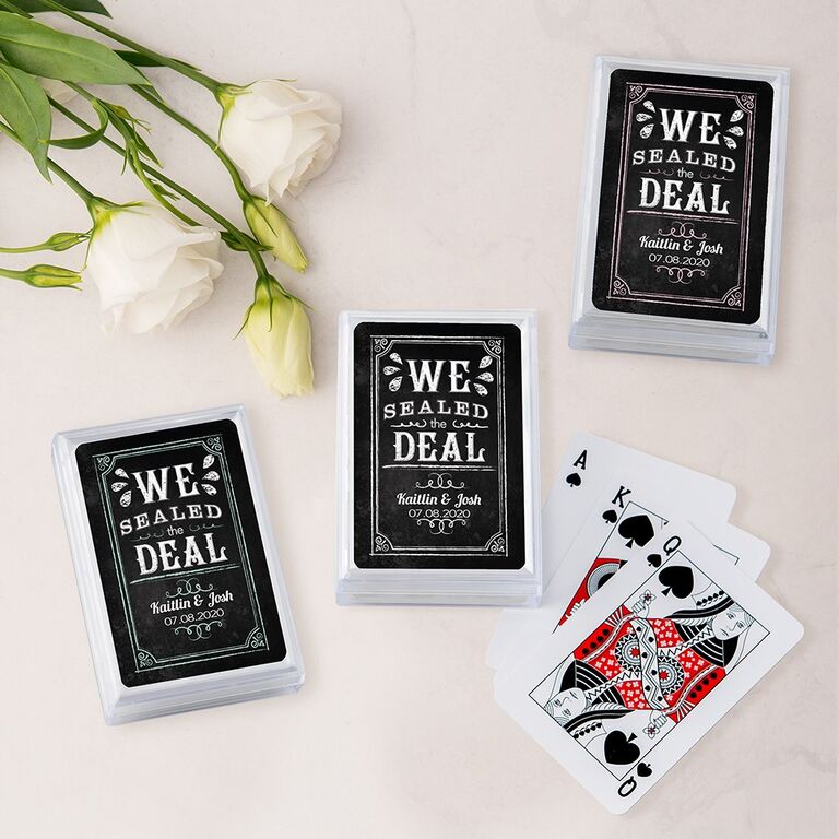 Sets of playing cards in a box with personalized labels. 
