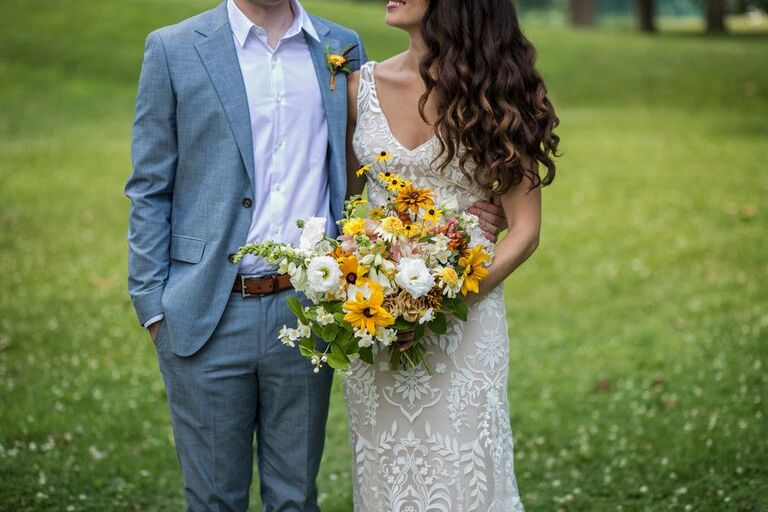 Bride holding wildflower-inspired bouquet with Black-eyed Susan blooms