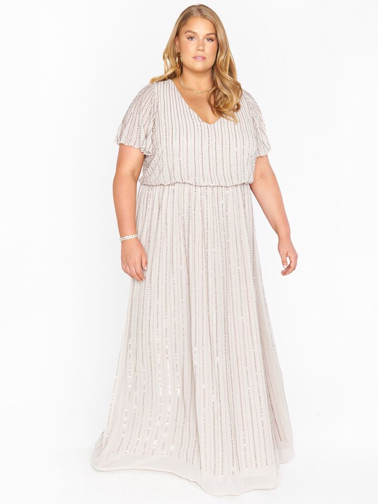 Floor length gown with flutter sleeve and vertical beading