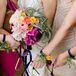 Instead of traditional bouquets, the girls carried a triangle instrument corsage adorned with vibrant ranunculus blooms and tiny air plants. A blue ribbon was designed to hang from the bridesmaid's wrist so they could provide a soft beat as they walked down the aisle.