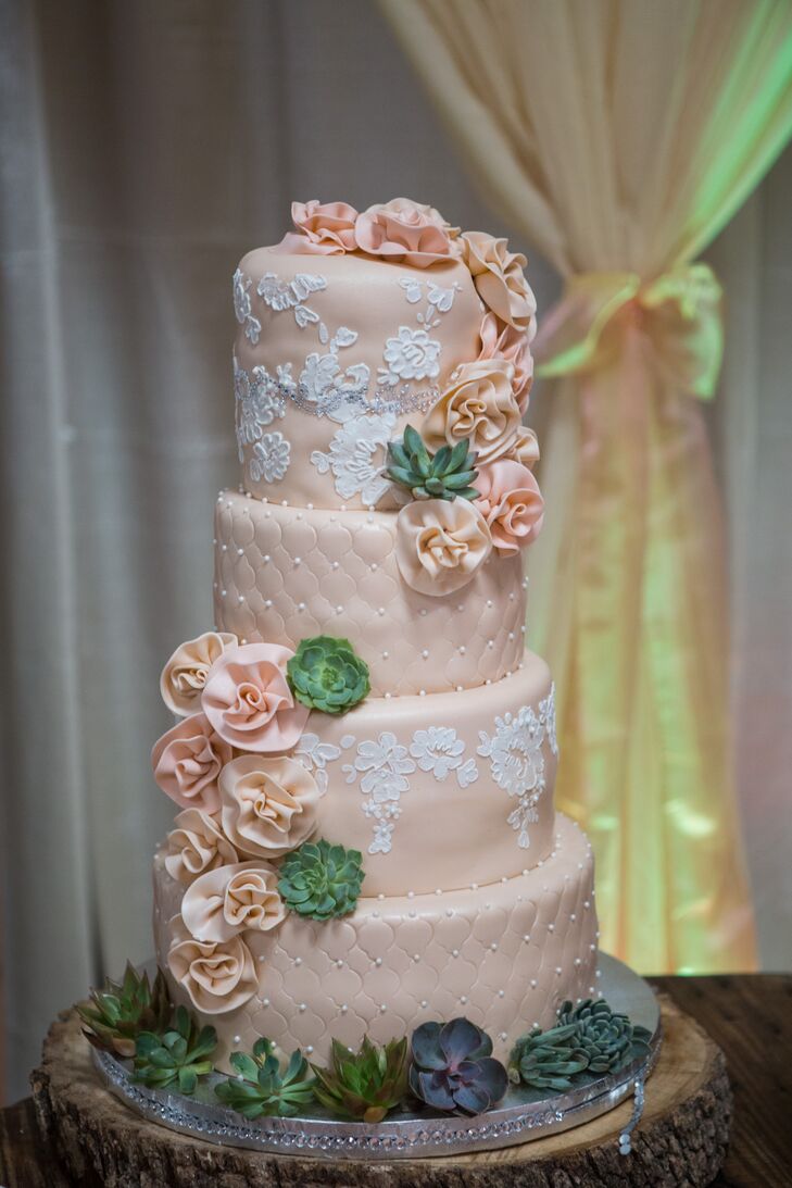 The wedding cake was the true expression of Texas meets Arizona: The four tiers of peach fondant incorporated the soft colors of the desert with Texas lace on two tiers and Arizona succulents scattered throughout the display.