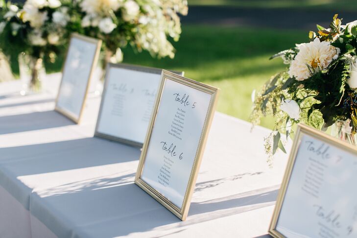 Table assignments were kept in spray-painted gold frames. The floral arrangements comrpised eucalyptus, rose, dahlia and greenery.