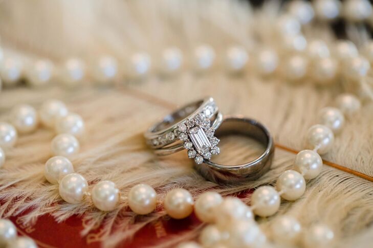 Jen's silver engagement ring rested among the wedding rings exchanged at the ceremony. "The ring is a gorgeous emerald-cut stone with a vintage-inspired halo and a solid, palladium band," Jen says. "Zac built and designed the ring all himself, and it still takes my breath away."