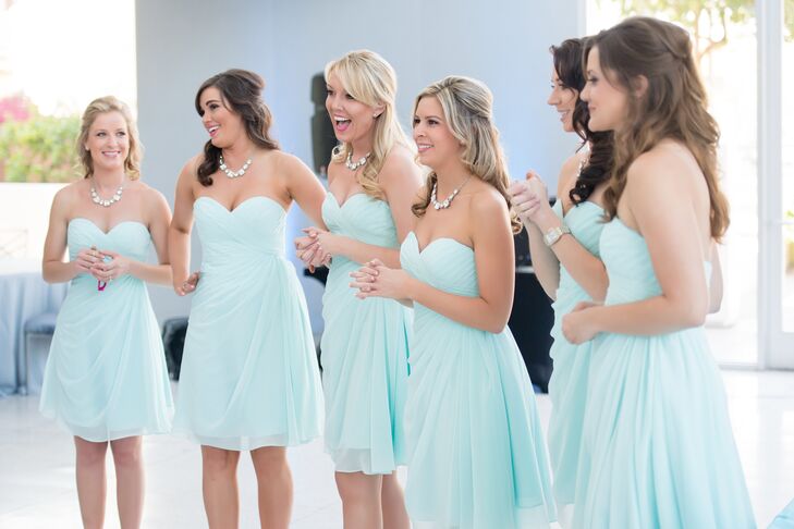 Brianna’s bridesmaids wore light aqua strapless chiffon dresses with crystal statement necklaces for a light, chic look that matched the venue and wedding style.