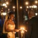 Romantic Couple Lighting Candle During Unity Ceremony