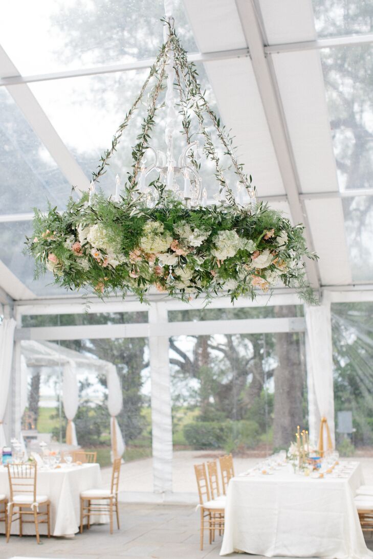 "My favorite feature of our decor was the fabulous, lush floral chandelier that Whitney from Branch put together," Nina says. "I loved the impact it made in the tent and how it tied our garden-party theme together." The gorgeous overgrown garden-inspired chandelier was 48 inches and was hung around a 16-lamp crystal chandelier. It included olive branches, jasmine vines, peach stock, white spray roses, white hydrangeas, peach garden roses and blush fringe tulips.