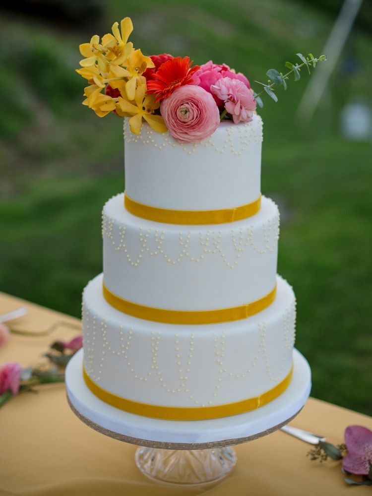 three-tier yellow-and-white spring wedding cake