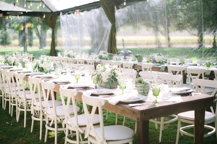 "I wanted the tables to look like someone (with impeccable taste) had pulled out their old dining room tables to the lawn and set up the most wonderful dinner for all of their closest friends," says Sloane. "For that reason, we had long farmhouse tables and only a runner down the middle. Each table each had one large box of flowers with hydrangeas, olive leaves, ivy, white daisies, roses and ferns as a centerpiece."