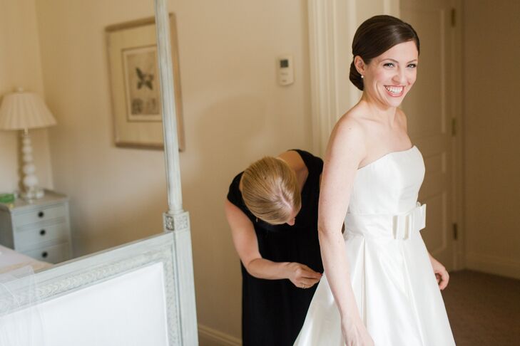 Lindsay wore a strapless, A-line wedding dress in raw silk with a clean bow at the waist by Justin Alexander. She wore a pair of simple pearl stud earrings, and her immaculate makeup was done by Beauty Mark.