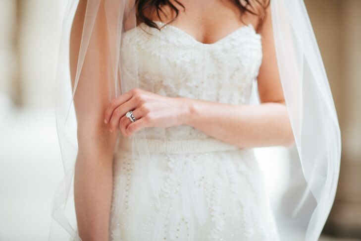 After searching high and low, the bride ultimately ended up trying on 19 dresses before finding the perfect gown. "I knew I wanted something super-feminine and fitted at the top," Liz says. "Plus, it had to be lightweight so I could dance!" The final choice? A white, strapless Monique Lhullier dress that caused her dad to break down in tears.