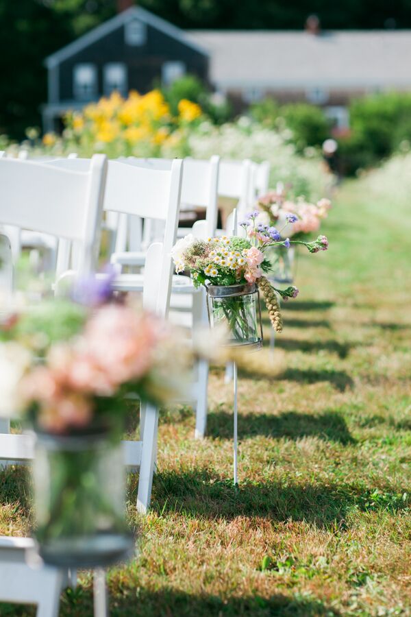 Megan and Jordan looked largely to flowers to bring the ceremony decor to life, and no detail was overlooked. In addition to a striking wedding arch dripping in ivory and blush florals, the aisles were lined with textured arrangements of pink, white and blush wildflowers.