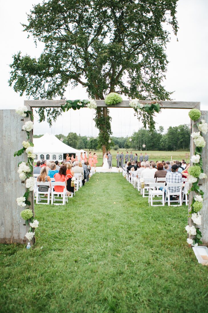 Green and White Hydrangea Decorated Rustic Barn Door Ceremonial Entranceway