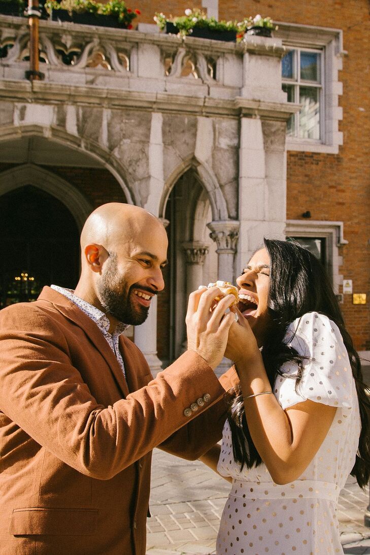 Couple Eating Doughnut During Wedding Portraits