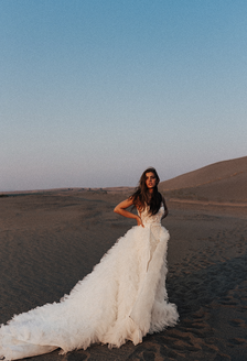 Bride in ruffled dress in desert
