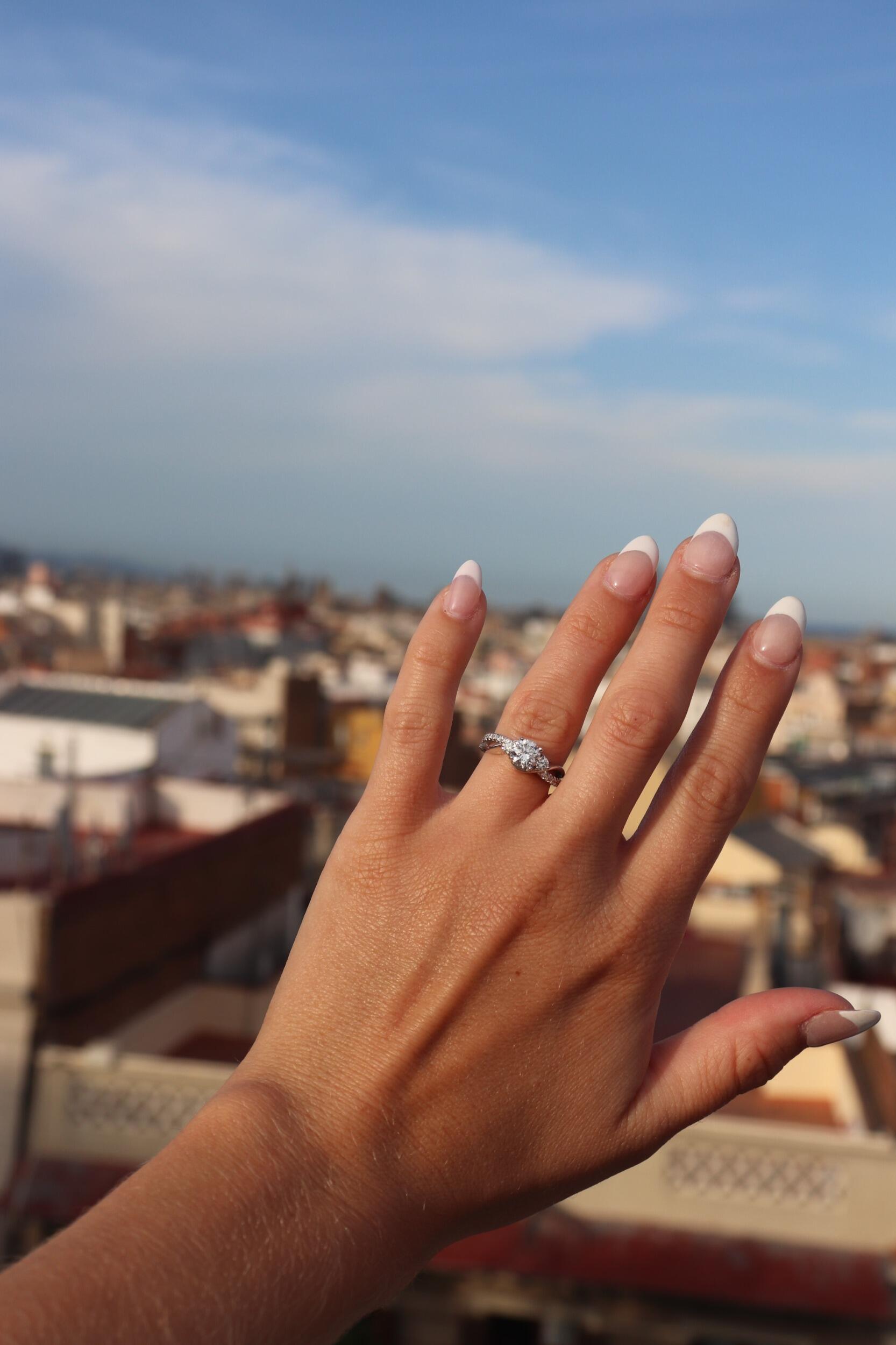 She said yes!! On their third Europe trip, Ben surprised Emma with a Barcelona getaway. On the first night of their adventure, back at the hotel, after a night of paella, patatas bravas, and Flamenco, he got down on one knee! 