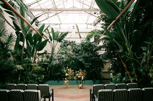 Industrial Greenhouse Ceremony Space With Trees, Plants and Greenery, Low Floral Arch