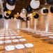 Indoor Ceremony Site with Brick Walls, Balloons and Ghost Chairs