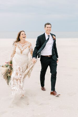 Bride and Groom Walk Along The Beach on Wedding Day