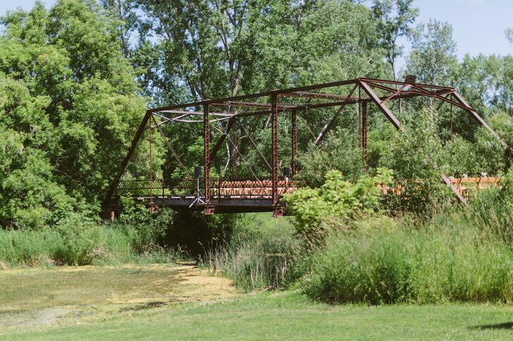 Megan and Carson had their ceremony on top of a iron bridge at Givens Farm in Hortonville, Wisconsin. Guests sat in wooden chairs arranged in rows to watch Megan and Carson get married.