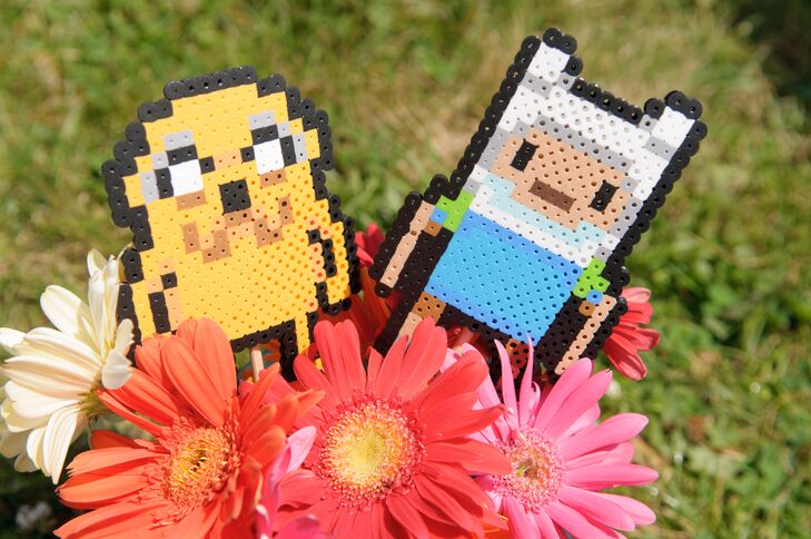 Jake and Finn (from the cartoon Adventure Time) perlers added a geeky touch to the bright coral and pink gerbera daisies on display.