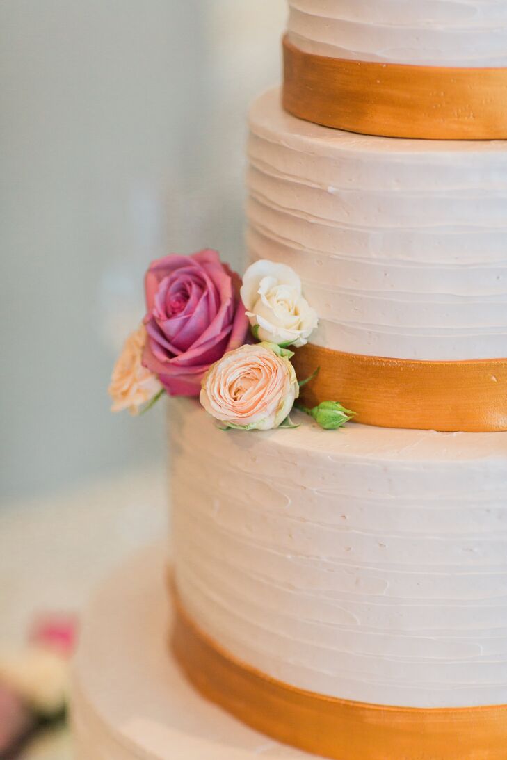 "I certainly didn't want ours to be a forgettable cake," Tara says of the orange and white confection. Flavors included a yellow cake tier filled with strawberry and white chocolate and a matcha almond cake for more adventurous guests.