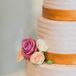 "I certainly didn't want ours to be a forgettable cake," Tara says of the orange and white confection. Flavors included a yellow cake tier filled with strawberry and white chocolate and a matcha almond cake for more adventurous guests.