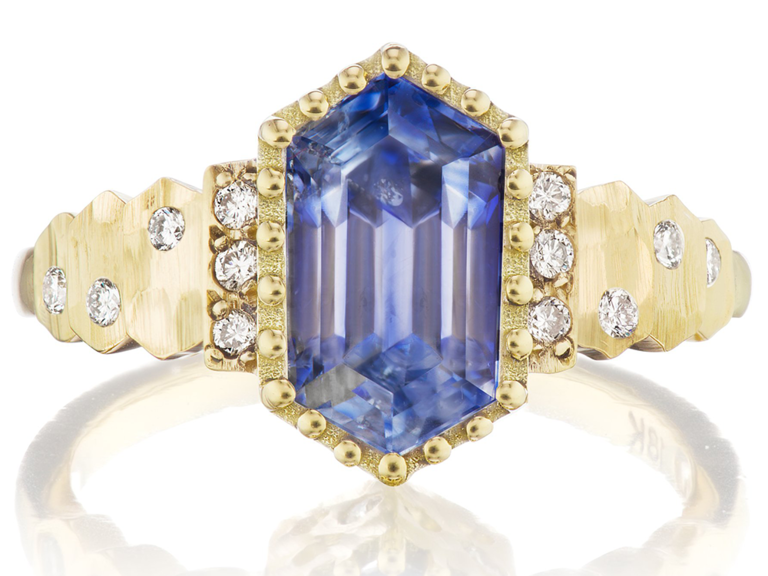 Hexagon blue sapphire in gold halo with diamond accents in thick gold band