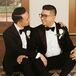 Grooms in Classic Black-and-White Tuxedos With Matching White Boutonnieres