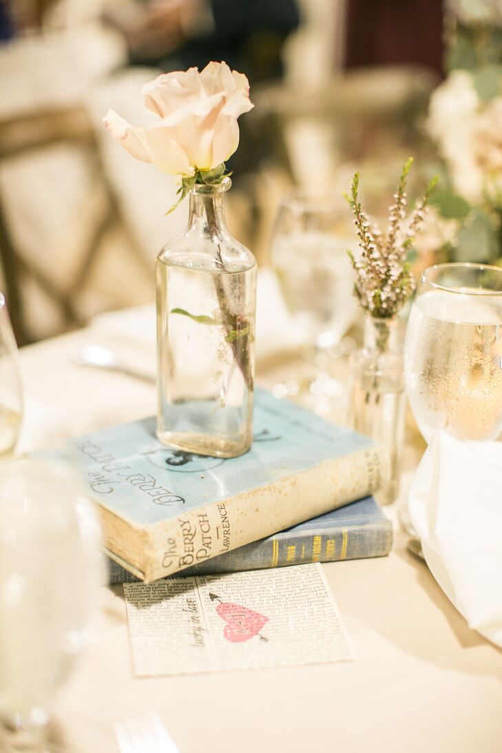The tablescape decor included candles, mason jar vases, simple wildflowers, glass bottle vases and vintage books.