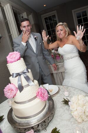 Four-Tier White Wedding Cake with Gray Bow and Pink Flowers