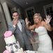 Four-Tier White Wedding Cake with Gray Bow and Pink Flowers