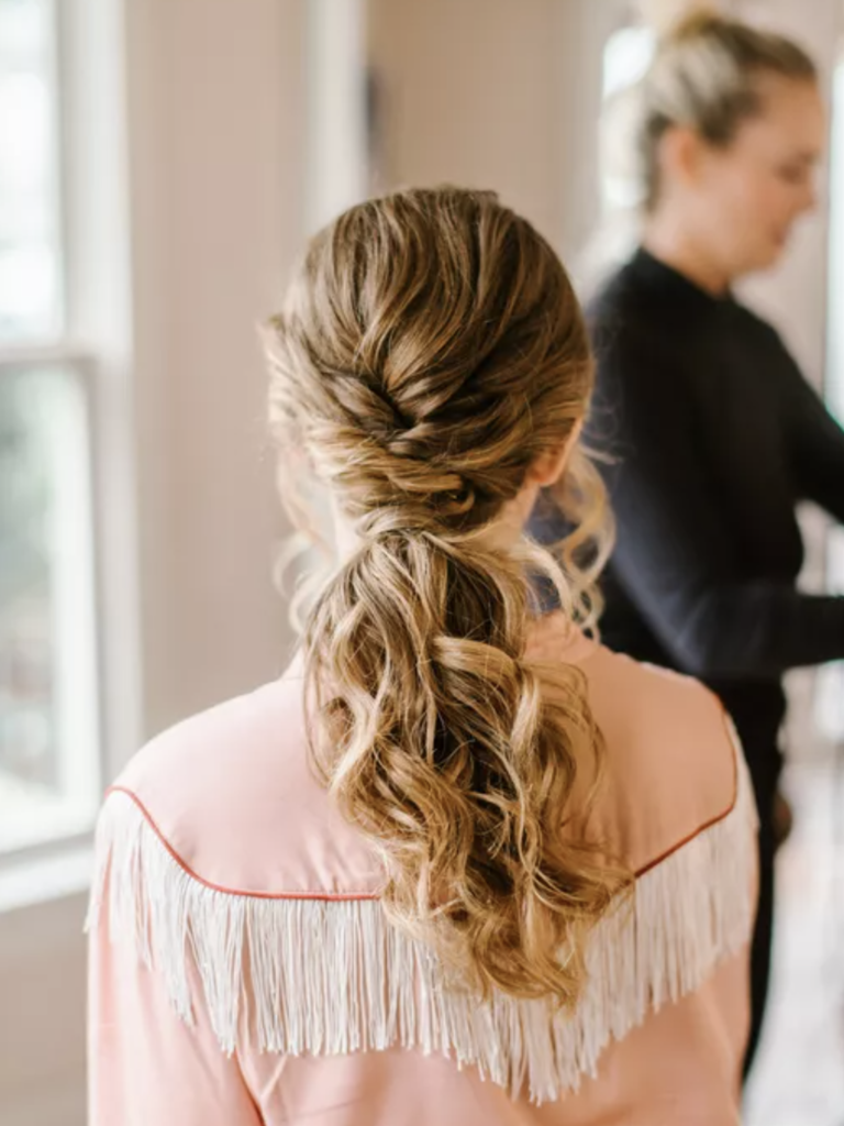 bride with braided updo ponytail