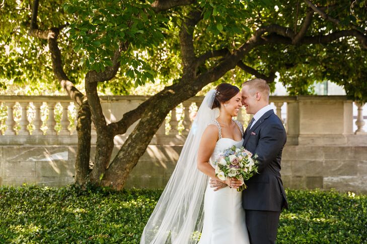 Jackie and Bryan embraced in happiness as they saw each other in their wedding attire for the first time. They both sported a very classic look—Jackie in a white silk strapless dress and Bryan in a charcoal gray suit with a black tie.