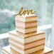 The bride won her wedding cake through the Carolina Bride "Dream Wedding Cake Giveaway" by submitting an essay describing the wedding cake of her dreams. Ines from Sky's the Limit Cakes created the sweet treat while a gold glitter cake topper completed the simple feel of the naked cake.