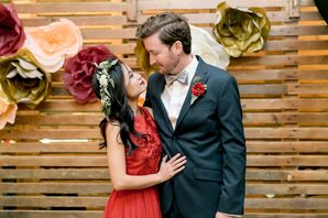 Boho Couple in front of a Paper Flower Garland
