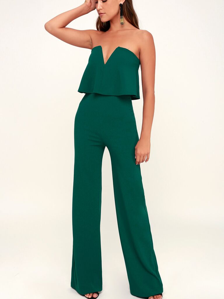 Model wearing a strapless green jumpsuit with cute tier in the center