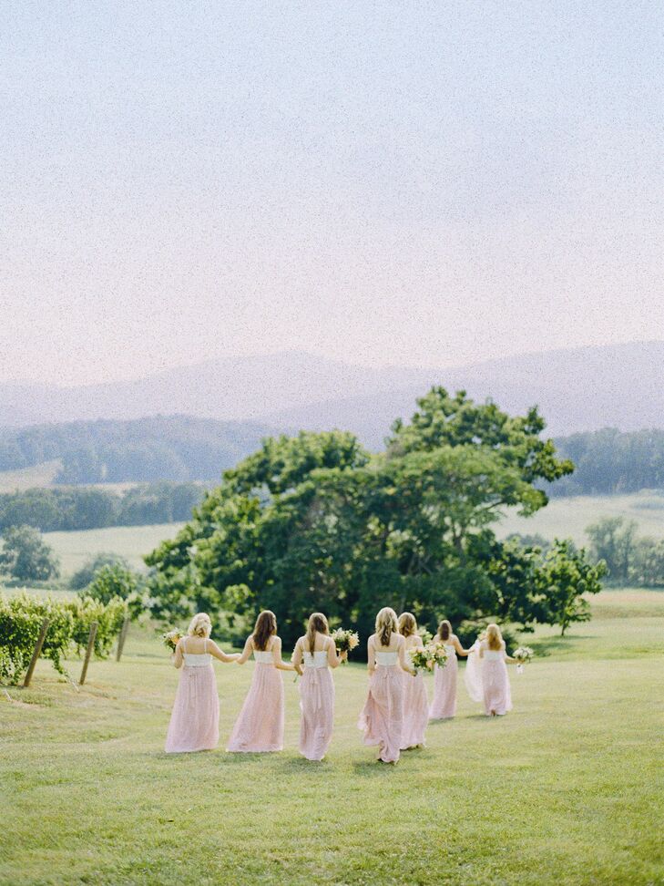 Inspired by her own two-piece style, Augusta dressed her bridesmaids in ivory bustiers and blush wrap skirts.