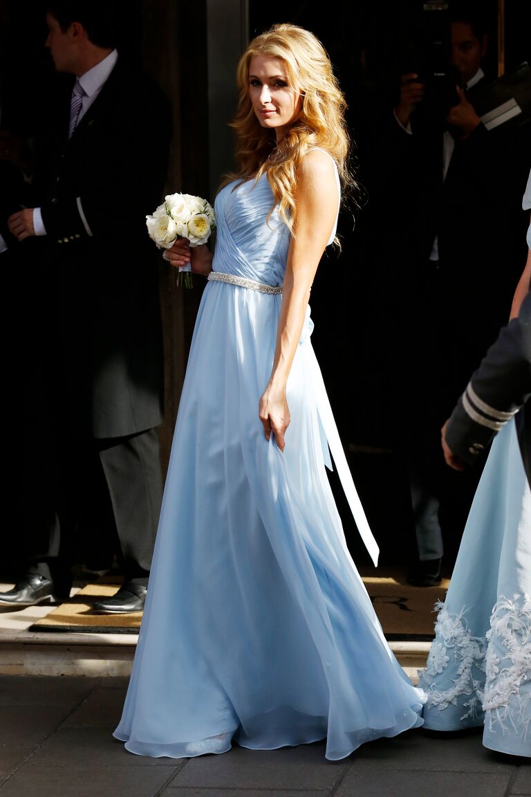 Paris Hilton wears a sky blue bridesmaids dress. 
