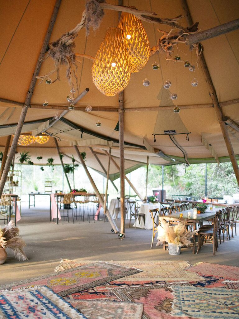 Macrame lighting fixtures at tented bohemian wedding reception